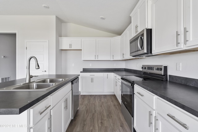 kitchen featuring white cabinetry, appliances with stainless steel finishes, sink, and a kitchen island with sink