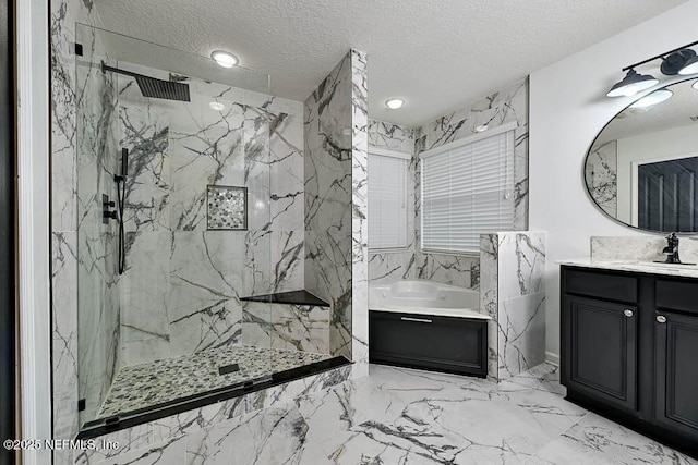 bathroom with vanity, a textured ceiling, and shower with separate bathtub