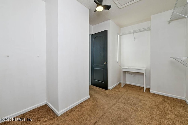 walk in closet with carpet flooring and ceiling fan