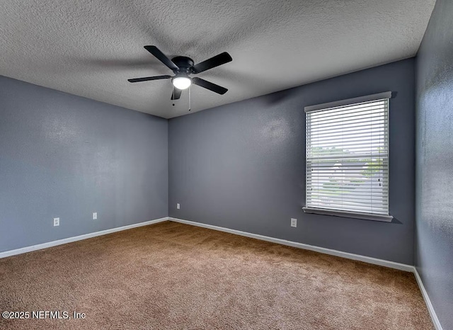 carpeted empty room featuring ceiling fan and a textured ceiling