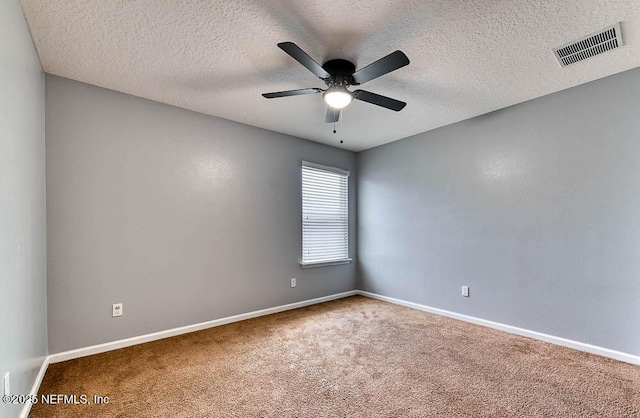 spare room with ceiling fan, carpet floors, and a textured ceiling