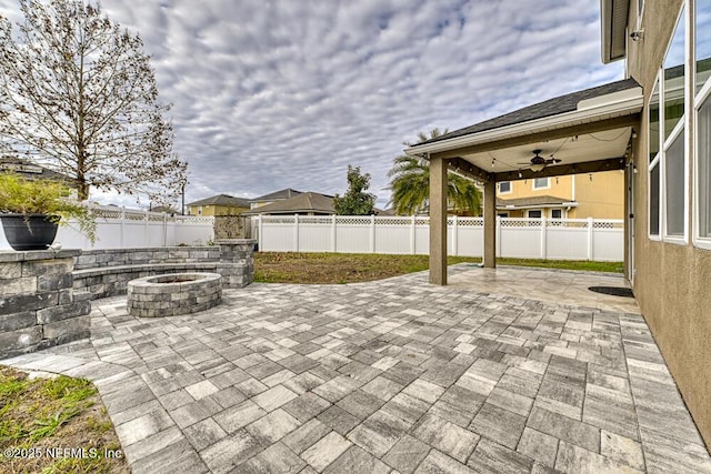 view of patio / terrace featuring a fire pit and ceiling fan