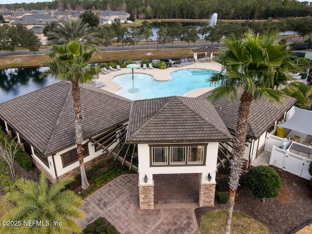 view of swimming pool with a water view and a patio