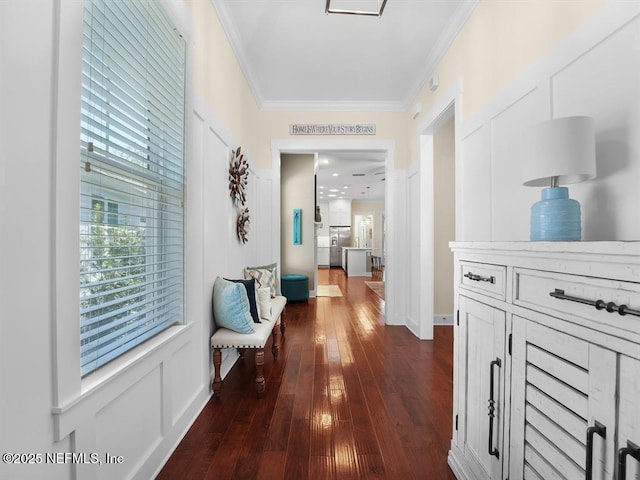 hall with dark hardwood / wood-style floors and crown molding