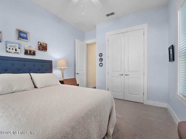 carpeted bedroom featuring ceiling fan and a closet