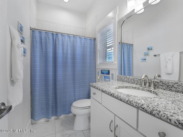 bathroom with vanity, toilet, and walk in shower