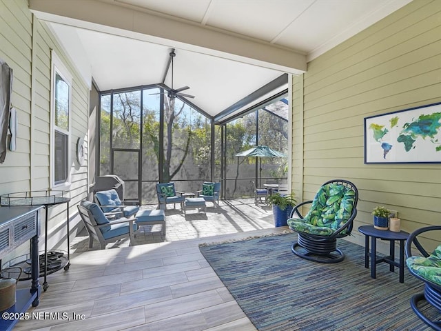 wooden deck featuring a lanai, a patio area, and an outdoor living space