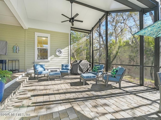 sunroom / solarium with a wealth of natural light, vaulted ceiling, and ceiling fan