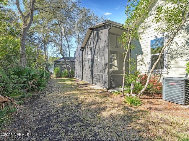 view of side of home with central AC