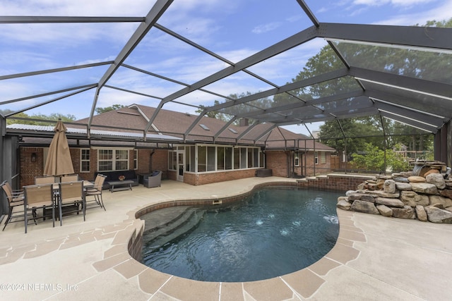 view of pool featuring a lanai and a patio area