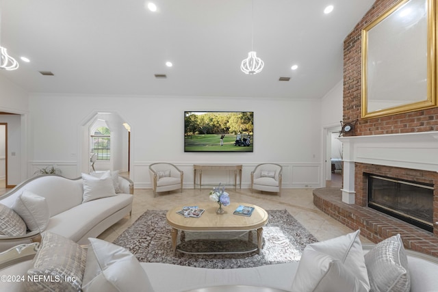 tiled living room with crown molding, a fireplace, and vaulted ceiling