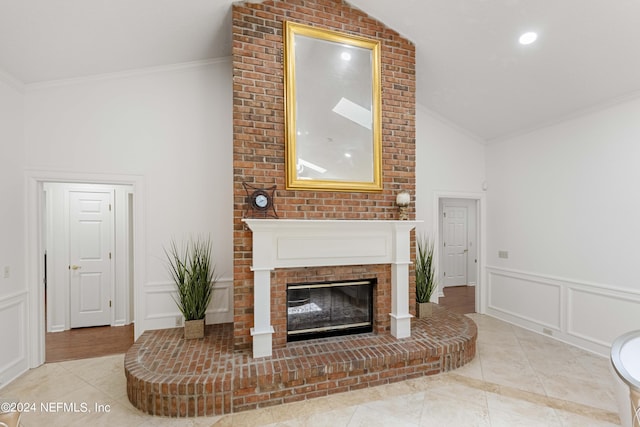 tiled living room with a fireplace, crown molding, and lofted ceiling