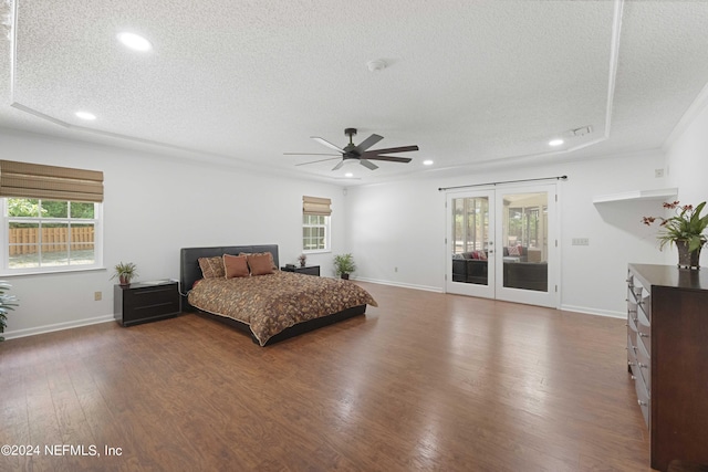 bedroom with a textured ceiling, access to exterior, ceiling fan, and multiple windows