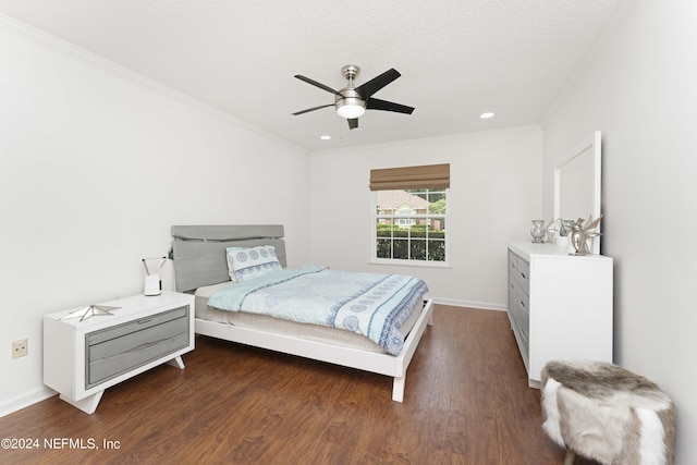 bedroom with ornamental molding, a textured ceiling, ceiling fan, and dark wood-type flooring