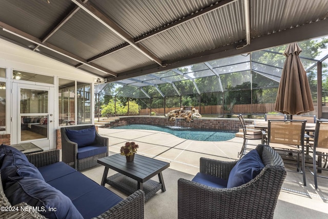 view of pool featuring a lanai, a patio area, pool water feature, and an outdoor living space