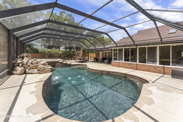 view of swimming pool featuring a lanai, central AC unit, a patio area, and pool water feature