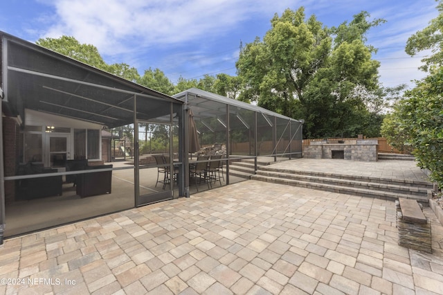 view of patio / terrace featuring glass enclosure