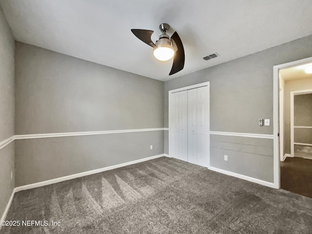 unfurnished bedroom with carpet floors, a closet, and ceiling fan