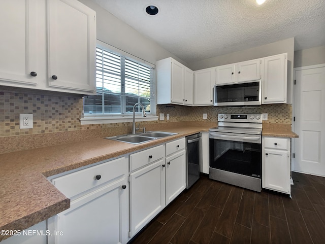 kitchen featuring sink, stainless steel appliances, a textured ceiling, decorative backsplash, and white cabinets