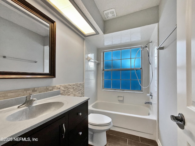 full bathroom featuring tile patterned floors, vanity, toilet, and shower / bath combination