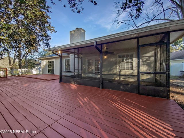 wooden deck with a sunroom