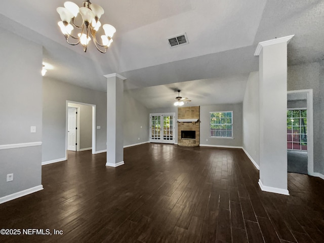 unfurnished living room with ceiling fan with notable chandelier, dark hardwood / wood-style flooring, lofted ceiling, and a wealth of natural light