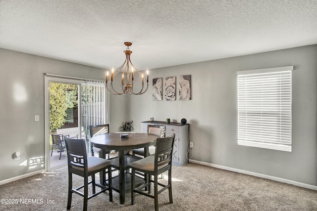 carpeted dining room with an inviting chandelier and a textured ceiling