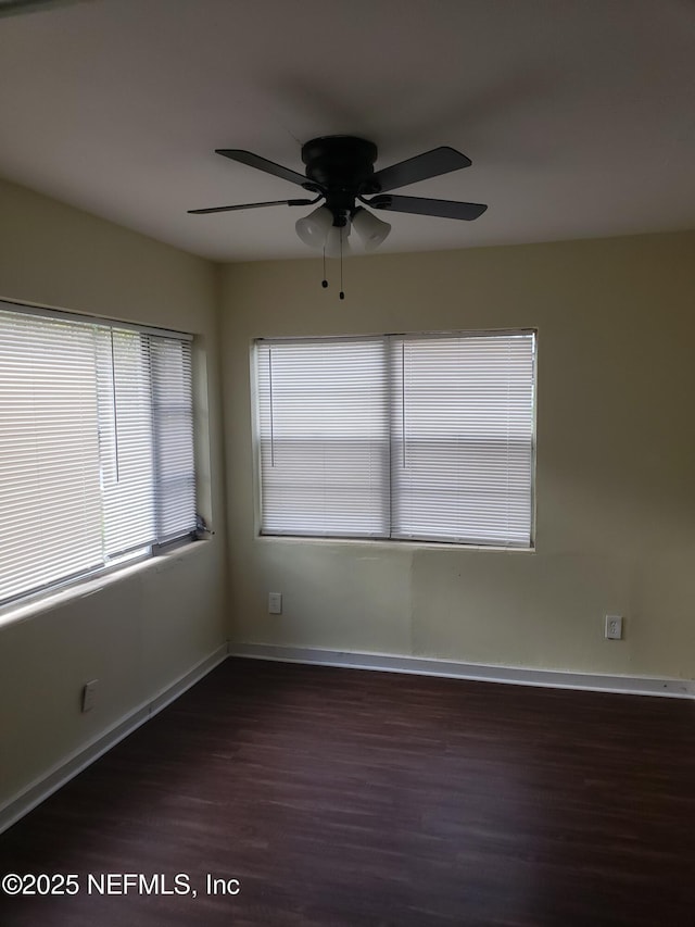 spare room featuring ceiling fan and dark hardwood / wood-style floors