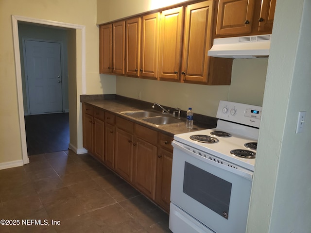 kitchen with dark tile patterned floors, electric stove, and sink