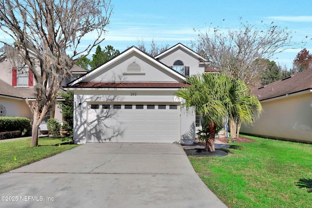 view of front of house featuring a garage and a front lawn