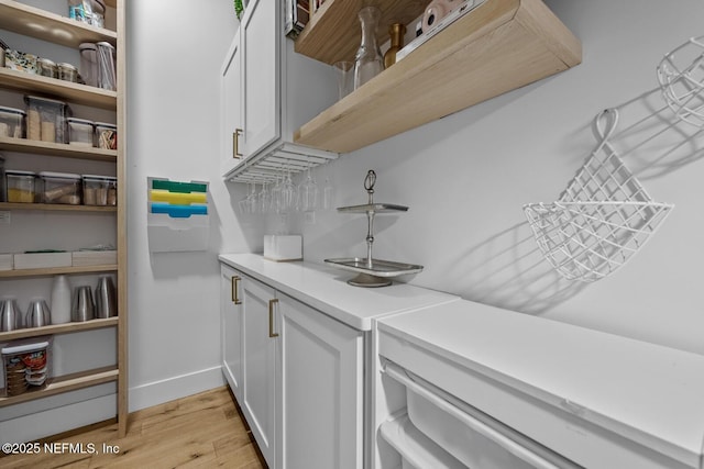 interior space featuring white cabinets and light hardwood / wood-style floors