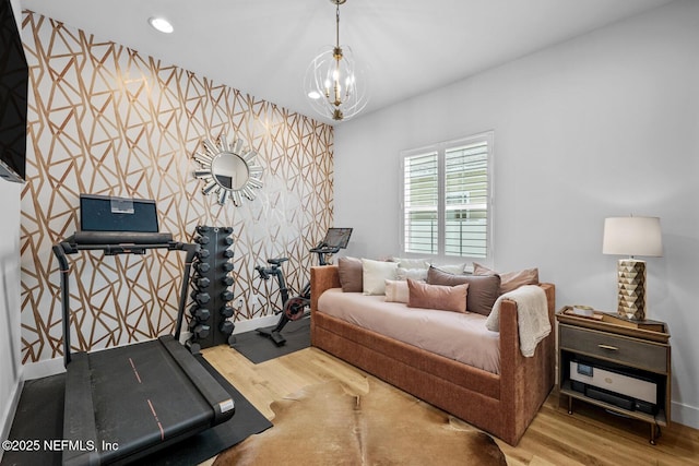 bedroom with wood-type flooring and a chandelier