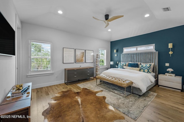 bedroom featuring light hardwood / wood-style floors, ceiling fan, and lofted ceiling