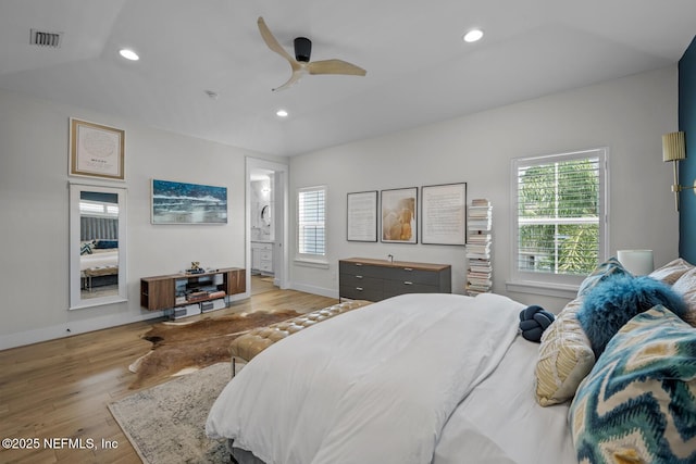 bedroom with connected bathroom, light hardwood / wood-style flooring, and ceiling fan