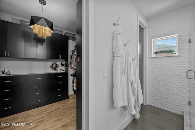 bathroom featuring a chandelier and an enclosed shower