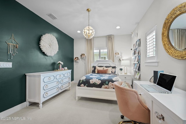 bedroom with a chandelier and light colored carpet