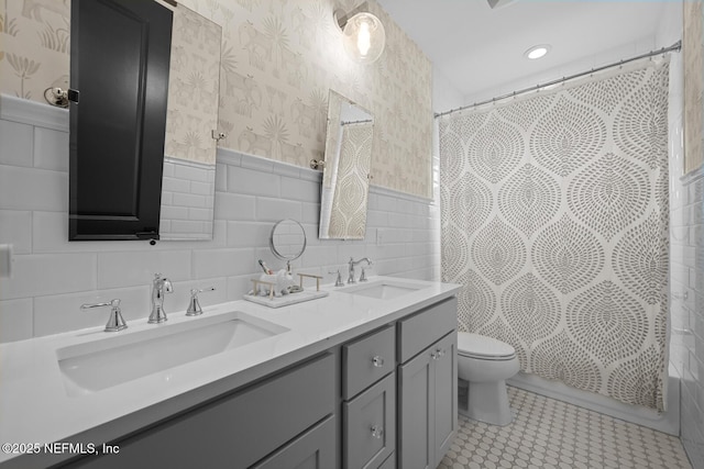 full bathroom featuring shower / bath combination with curtain, vanity, tile walls, tile patterned flooring, and toilet