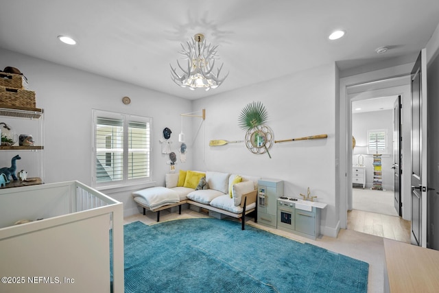 bedroom featuring a crib and a chandelier