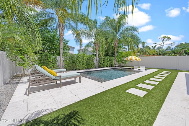 view of pool featuring a lawn and a patio area