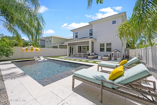 view of pool featuring a patio area, a sunroom, and an outdoor hangout area