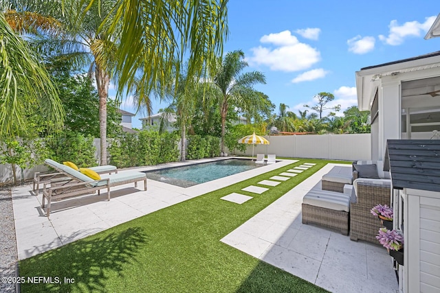 view of pool with a yard and a patio