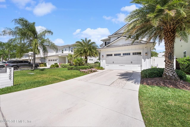 view of front of property with a garage and a front lawn