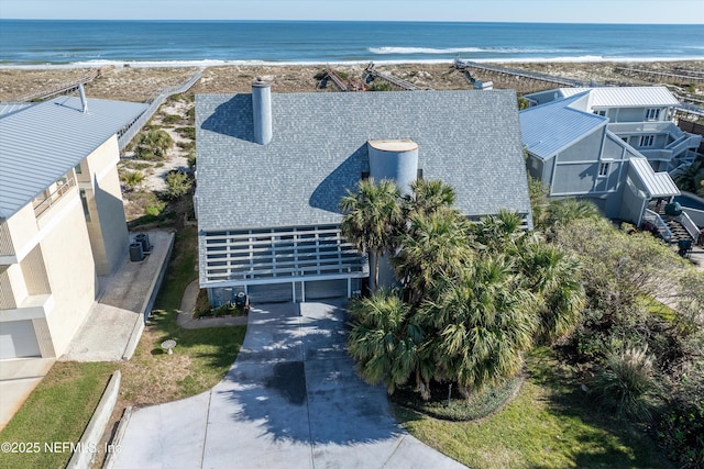 drone / aerial view with a water view and a view of the beach