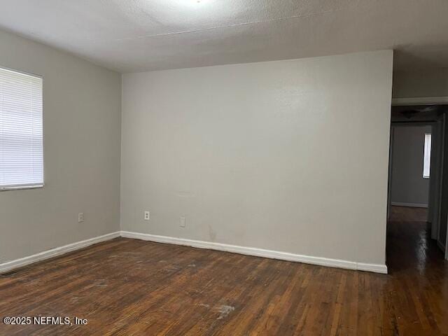 empty room featuring dark wood-type flooring