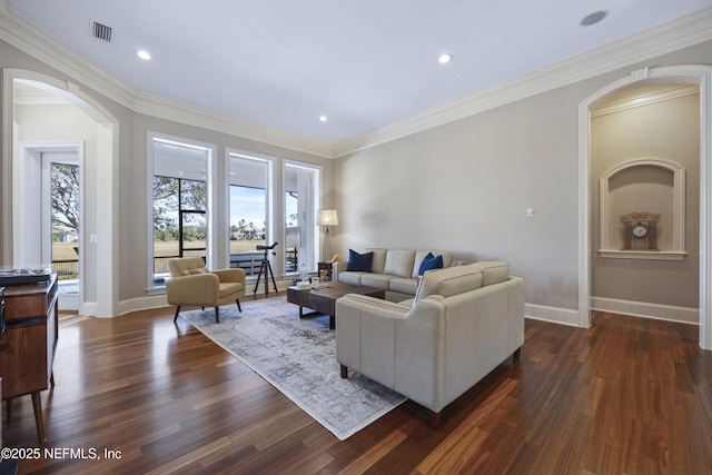 living room featuring dark hardwood / wood-style flooring and crown molding