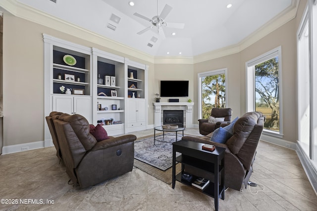 living room with ceiling fan, crown molding, and vaulted ceiling