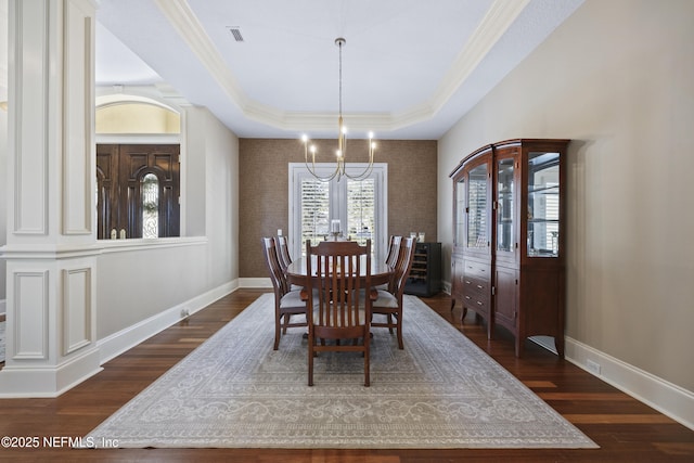 dining room with french doors, a raised ceiling, crown molding, a notable chandelier, and dark hardwood / wood-style flooring