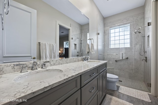 bathroom featuring wood-type flooring, vanity, toilet, and walk in shower