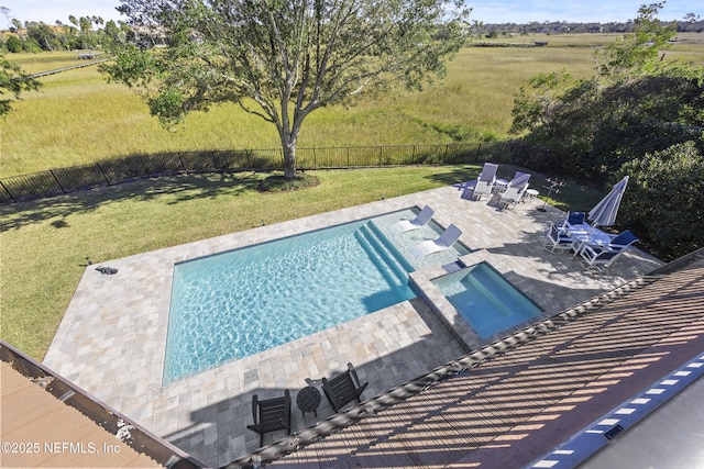 view of swimming pool featuring a lawn and a patio