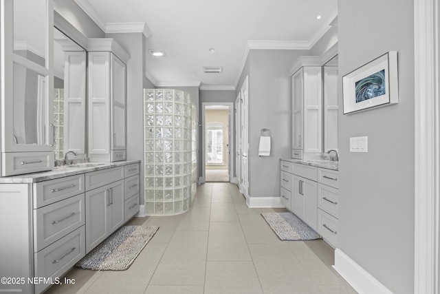 bathroom with tile patterned floors, crown molding, and vanity